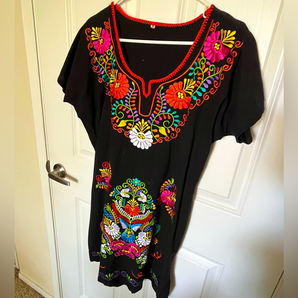Authentic Mexican Embroidered Dress. Black background Colorful embroidered